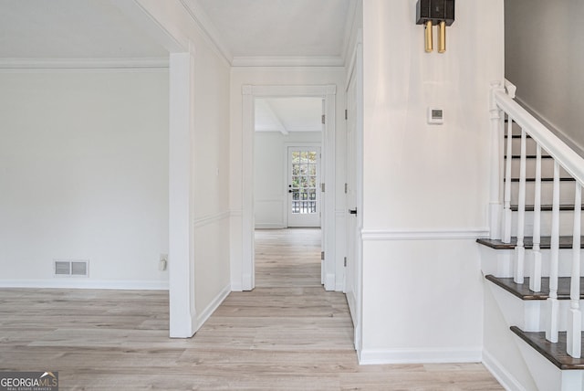 corridor featuring crown molding and light hardwood / wood-style flooring