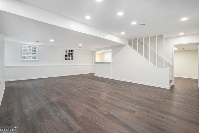 unfurnished living room with dark wood-type flooring