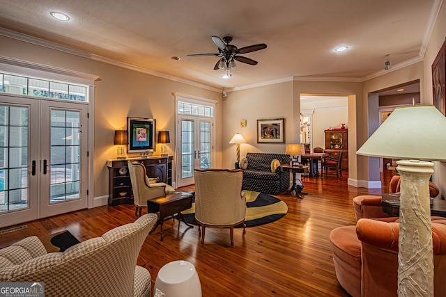 living room with ceiling fan, french doors, hardwood / wood-style floors, and ornamental molding