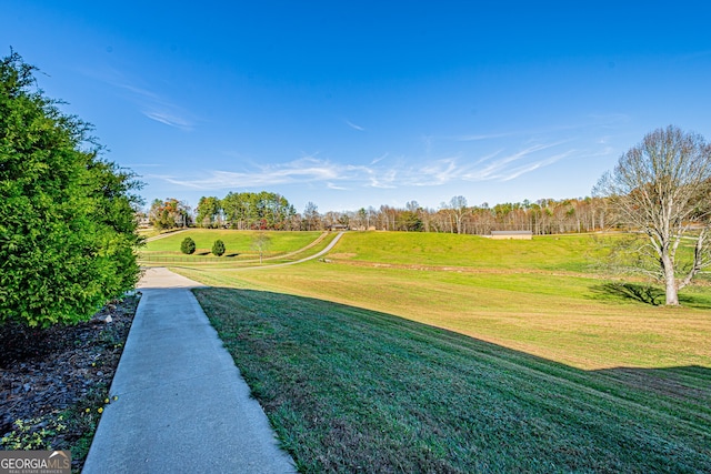 view of home's community with a yard and a rural view