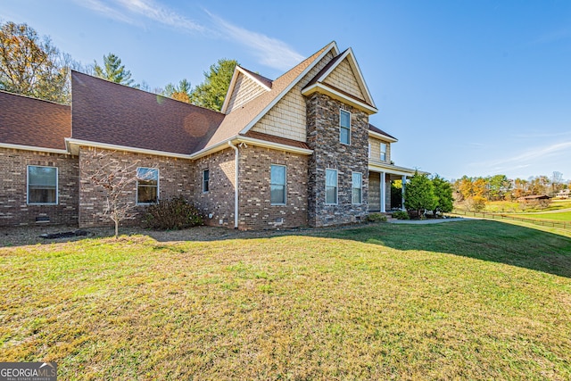 rear view of house featuring a lawn