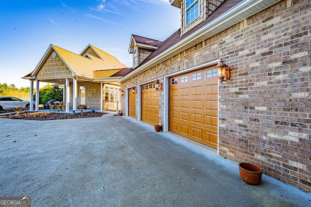 exterior space featuring covered porch and a garage