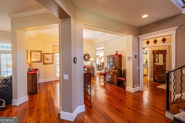 hall with crown molding and wood-type flooring