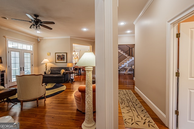 corridor with a chandelier, french doors, wood-type flooring, and ornamental molding