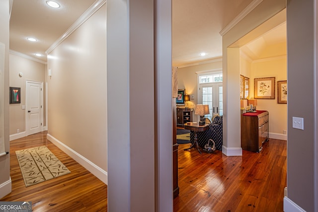 corridor with french doors, ornamental molding, and hardwood / wood-style flooring