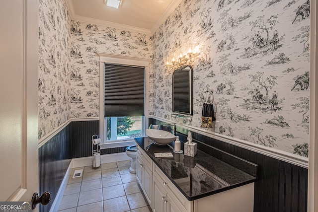 bathroom with tile patterned flooring, vanity, toilet, and crown molding