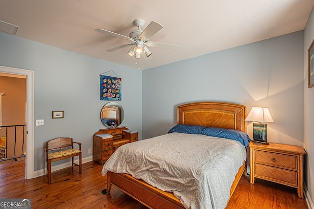 bedroom with ceiling fan and wood-type flooring