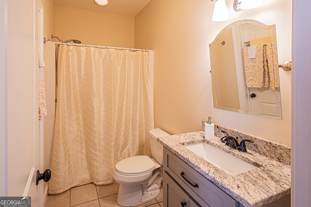 bathroom featuring tile patterned flooring, vanity, toilet, and walk in shower