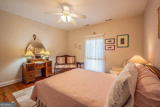 bedroom featuring ceiling fan and dark hardwood / wood-style flooring