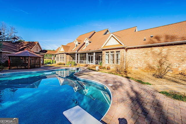 view of pool featuring a gazebo, a diving board, and a sunroom