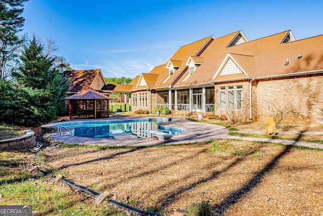 view of swimming pool featuring a gazebo, a patio, a diving board, and a sunroom