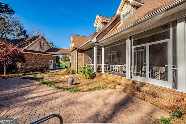 view of patio / terrace featuring a sunroom