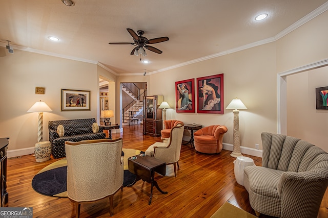 living room with crown molding, ceiling fan, and hardwood / wood-style flooring