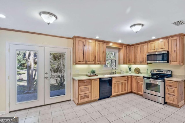 kitchen featuring appliances with stainless steel finishes, french doors, crown molding, sink, and light tile patterned flooring