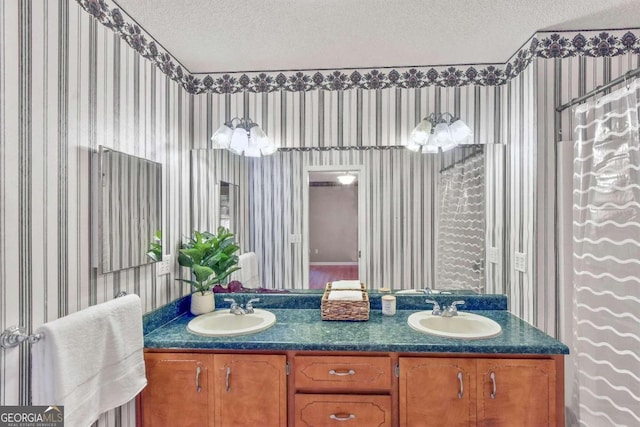 bathroom with vanity, a shower with curtain, and a textured ceiling