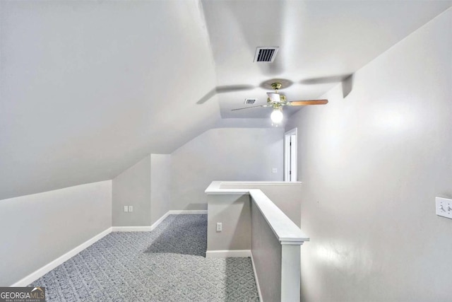 interior space with carpet, ceiling fan, and lofted ceiling