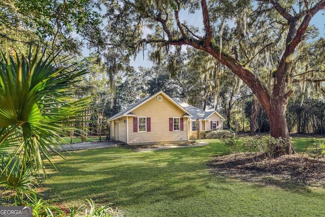 view of side of home with a yard and a garage