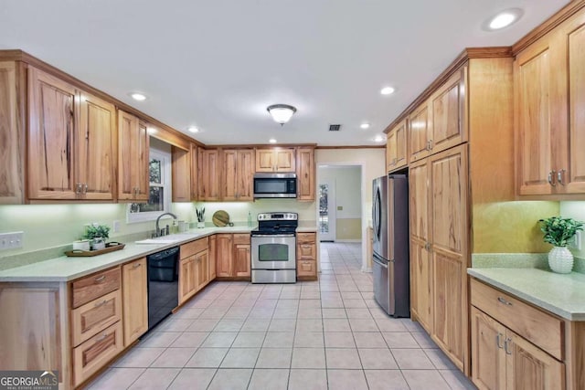 kitchen featuring sink, light tile patterned flooring, and appliances with stainless steel finishes