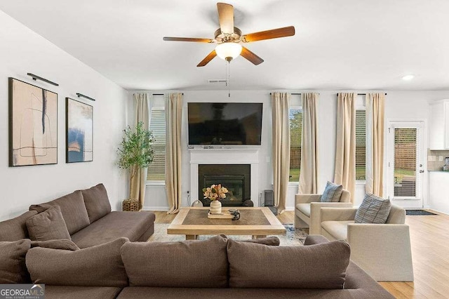 living room with ceiling fan and light wood-type flooring