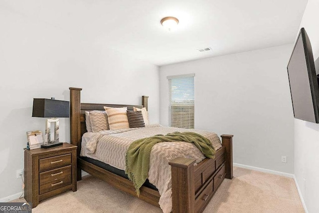 bedroom with light colored carpet