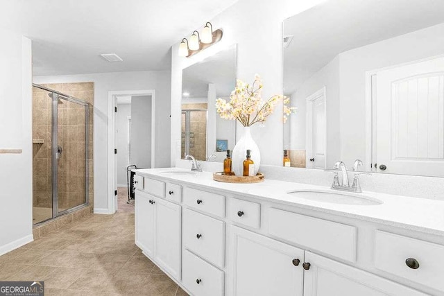 bathroom featuring tile patterned floors, vanity, and an enclosed shower