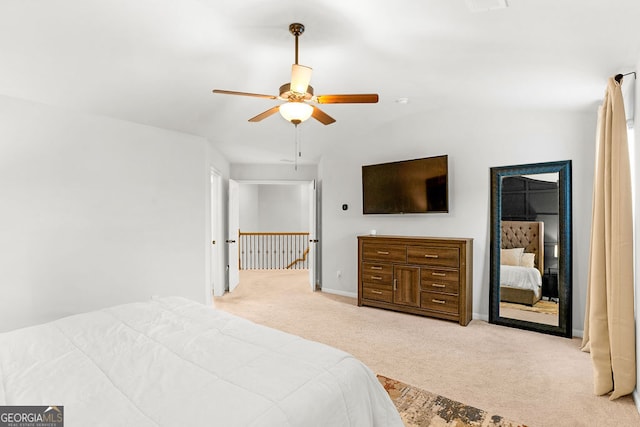 carpeted bedroom with ceiling fan and vaulted ceiling