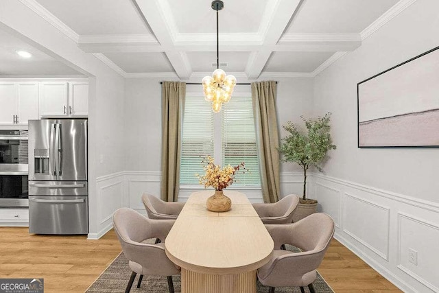 dining space featuring light wood-type flooring, coffered ceiling, crown molding, a notable chandelier, and beamed ceiling