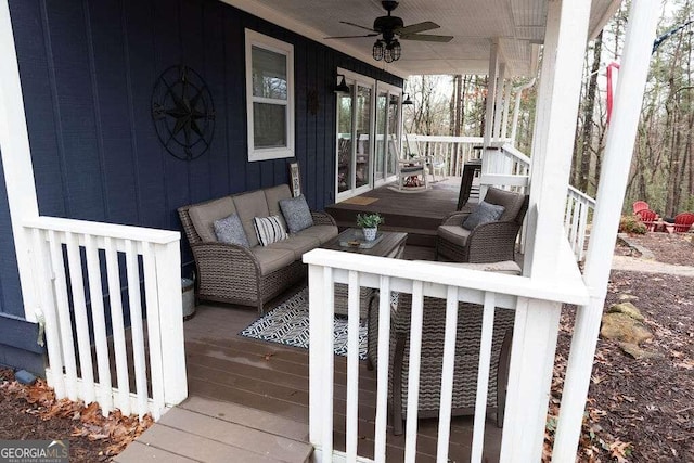 wooden terrace featuring ceiling fan and a porch