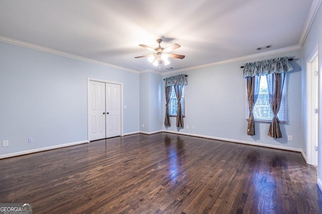 spare room featuring dark hardwood / wood-style floors, ceiling fan, and crown molding