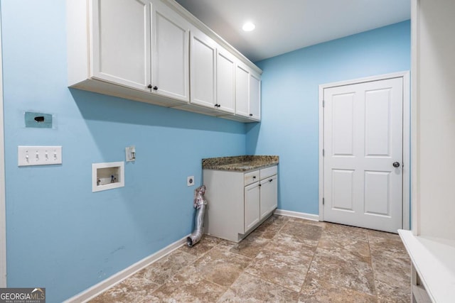 laundry area with hookup for an electric dryer, washer hookup, and cabinets