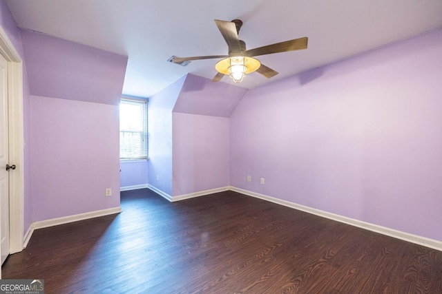 additional living space with ceiling fan, dark hardwood / wood-style flooring, and vaulted ceiling