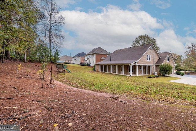 exterior space featuring a yard and a playground