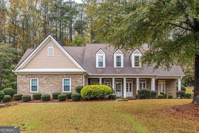 view of front of home with a porch and a front yard