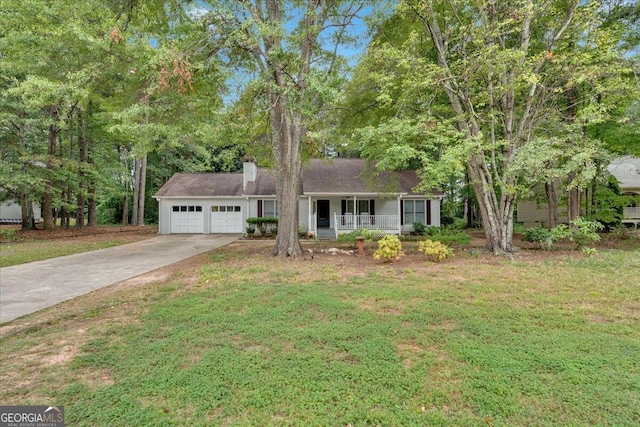 view of front of home with covered porch, a front yard, and a garage