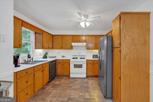 kitchen with appliances with stainless steel finishes, a textured ceiling, ceiling fan, and sink