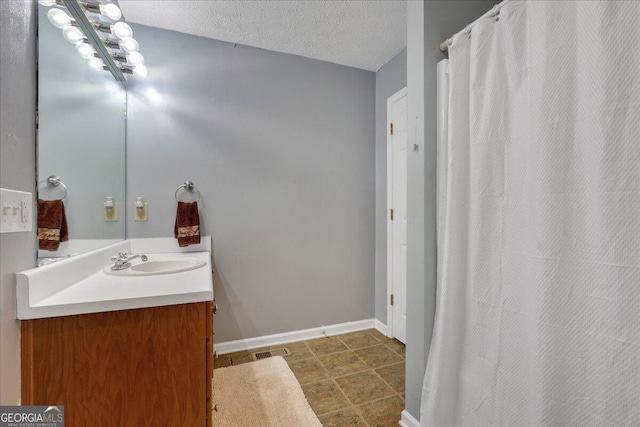 bathroom featuring vanity and a textured ceiling