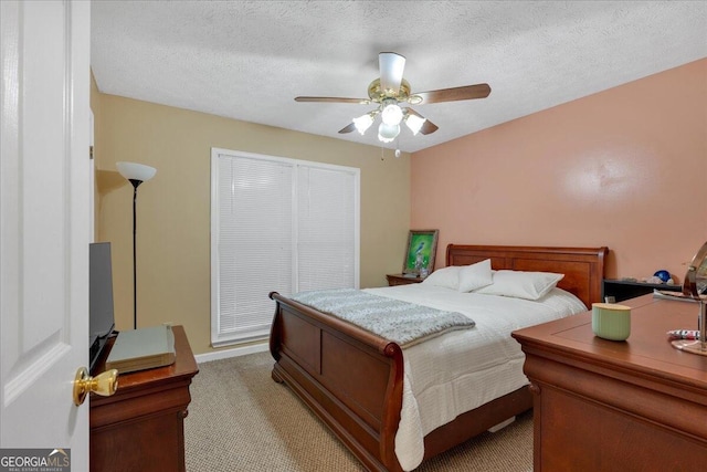 carpeted bedroom with a textured ceiling and ceiling fan