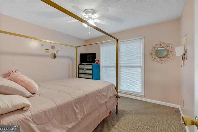 carpeted bedroom featuring ceiling fan and a textured ceiling