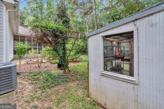 view of yard with a sunroom and central AC