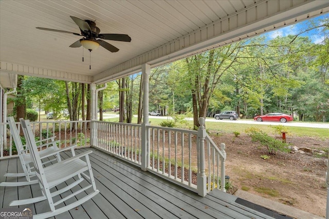 wooden terrace with ceiling fan and a porch