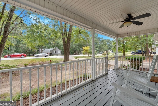 wooden terrace featuring ceiling fan and covered porch