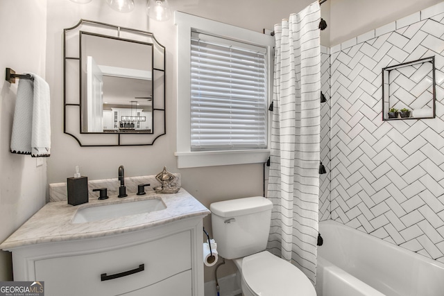 full bathroom featuring vanity, shower / bath combination with curtain, and toilet