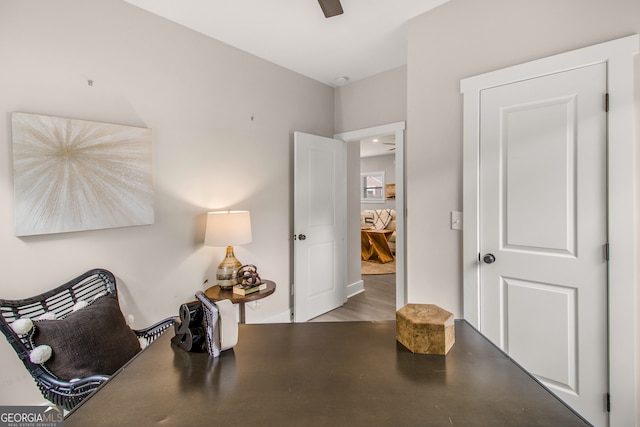 home office with light hardwood / wood-style flooring and ceiling fan