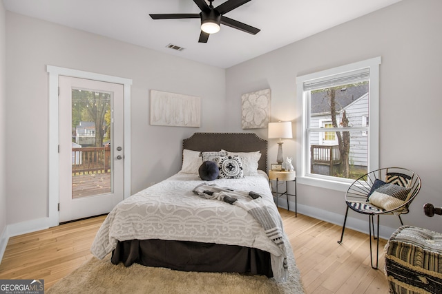 bedroom with access to exterior, light hardwood / wood-style floors, and ceiling fan