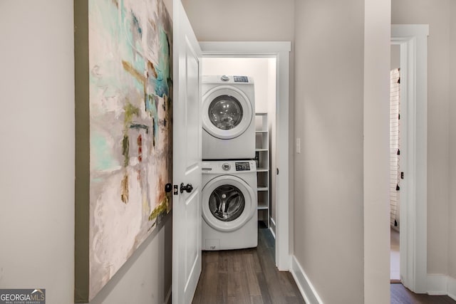 laundry room featuring dark hardwood / wood-style flooring and stacked washer / dryer