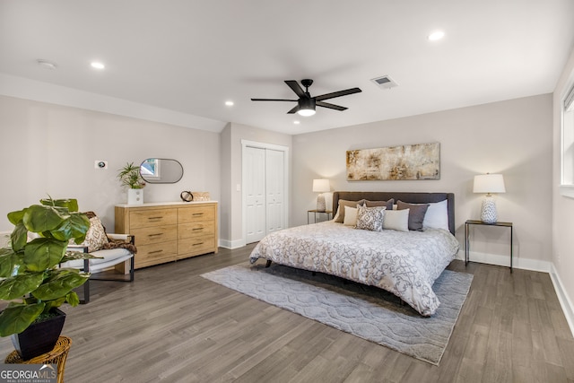 bedroom with ceiling fan, a closet, and hardwood / wood-style flooring