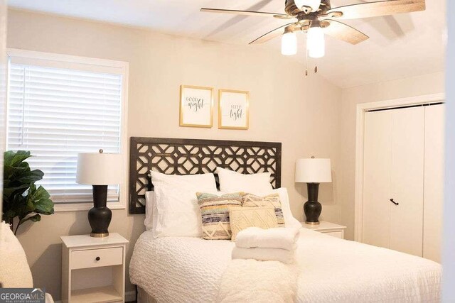 bedroom with ceiling fan and a closet