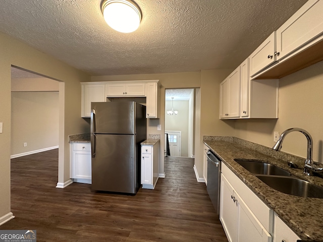 kitchen featuring white cabinets, sink, stainless steel appliances, and dark wood-type flooring