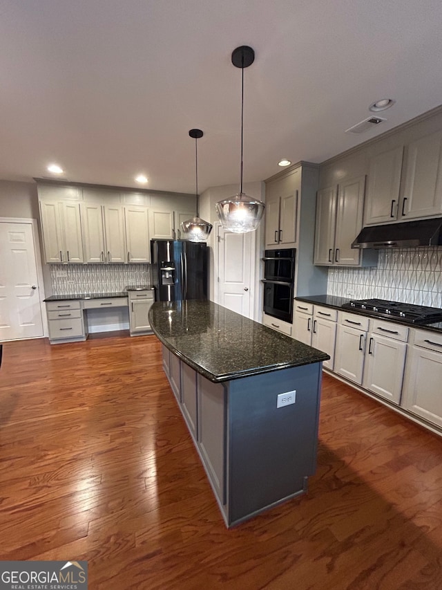 kitchen featuring black appliances, dark hardwood / wood-style flooring, and backsplash