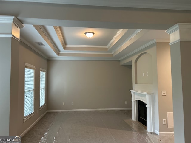 unfurnished living room with a raised ceiling, crown molding, and dark carpet